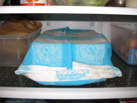 Plastic tub wrapped in teatowel and placed in fridge