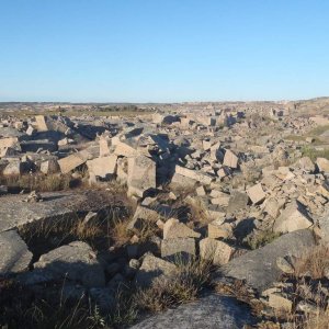 stone quarry

Good for hibernation and protection during summer.
In Winter temerature might be -30°C (-22°F) with storm winds.