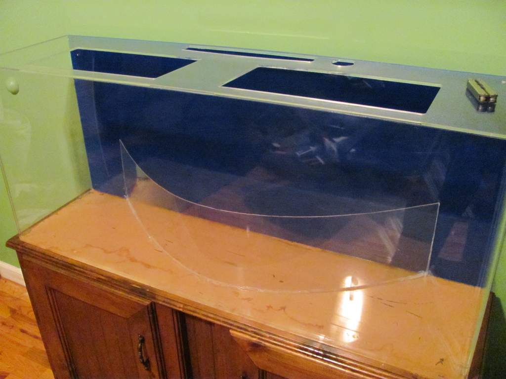 I used thin plexiglass to divide the water and ground. I wedged the pane between to heavy objects to keep it bent. Then I used a space heater to softe